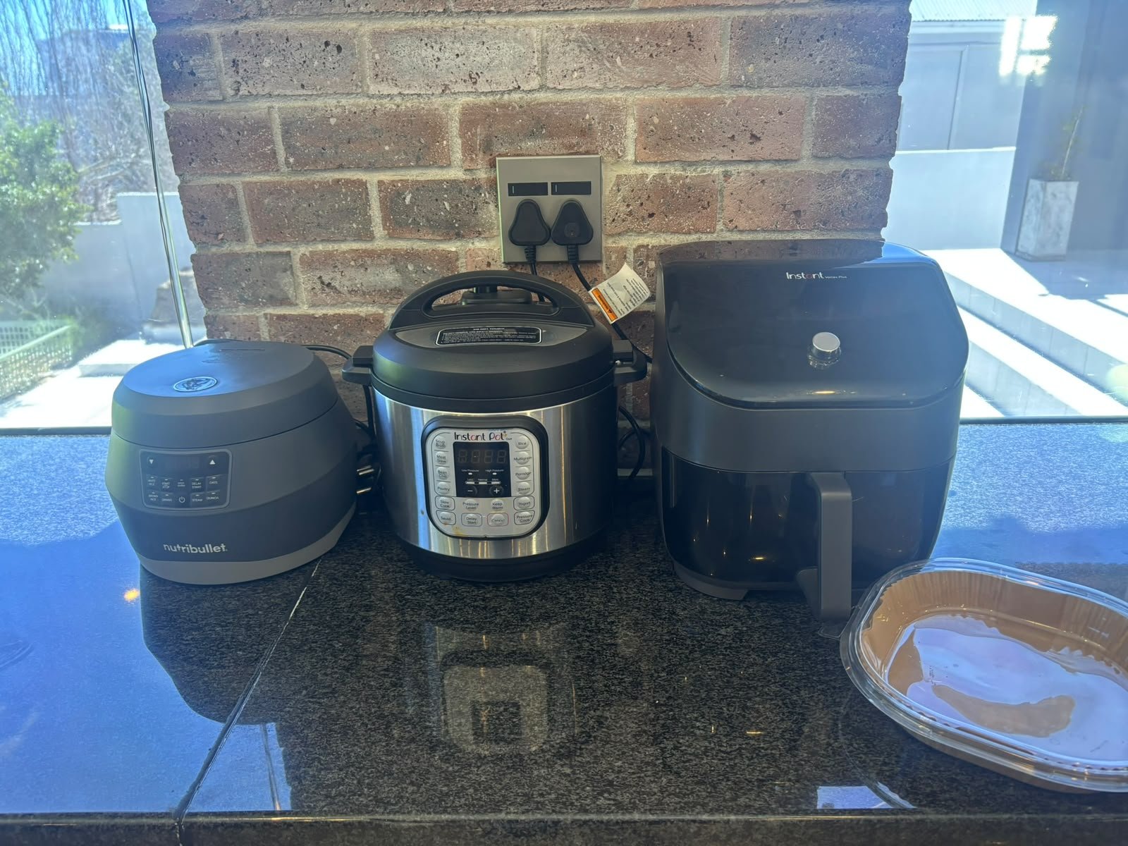 My Nutribullet rice cooker, Instant Pot and Instant Vortex air fryer lined up on the kitchen counter